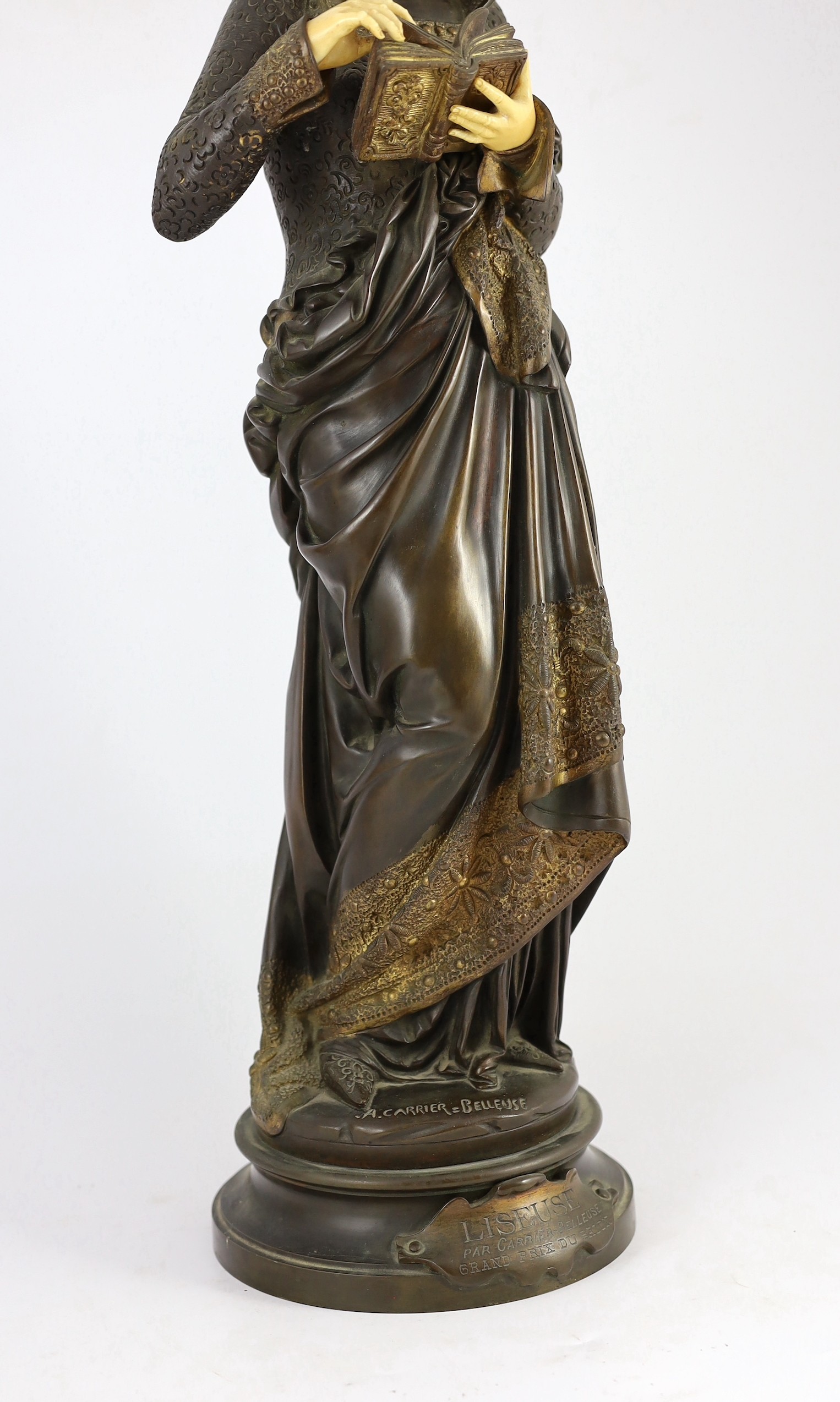 Albert-Ernest Carrier-Belleuse (French, 1824-1887). A parcel gilt bronze and ivory figure, 'Liseuse', height 60cm
